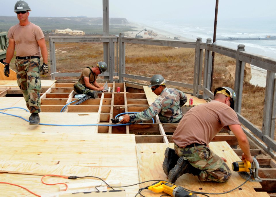 US Navy 080703-N-1424C-798 Seabees assigned to Amphibious Construction Battalion (ACB) 1 reconstruct the deck of a platform overlooking Red Beach