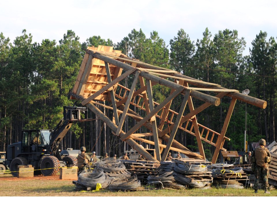 US Navy 080630-N-1120L-046 Seabees assigned to Naval Mobile Construction Battalion (NMCB) 7 work together to raise a timber tower at the unit's forward operations base during the battalion's unit field exercise (FEX)