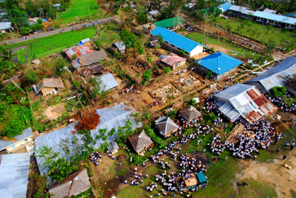 US Navy 080701-N-0640K-210 Residents from the Municipality of Balasan, Philippines wave and cheer after Sailors assigned to the