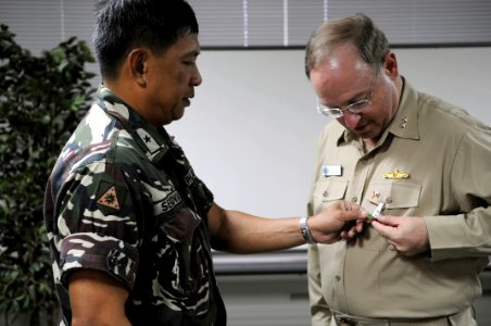 US Navy 080702-N-3659B-231 Armed Forces of the Philippines (AFP) Brig. Gen. Jorge V. Segovia presents Rear Adm. James P. Wisecup, commander of the Ronald Reagan Carrier Strike Group, with the AFP Disaster Response and Recovery