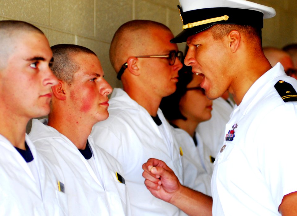 US Navy 080702-N-4565G-004 An upper-class Midshipmen instructs a Plebe from class 2012 on military bearing during Induction Day at the Naval Academy