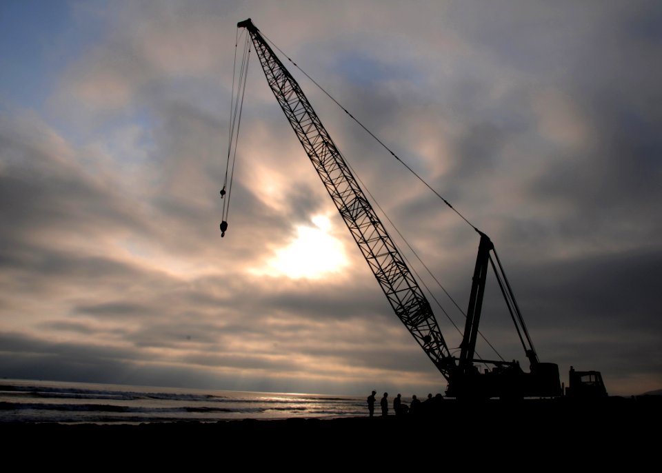 US Navy 080708-N-1424C-341 The sun sets as Seabees prepare for crane operations to construct an elevated causeway during Joint Logistics Over-The-Shore (JLOTS) 2008