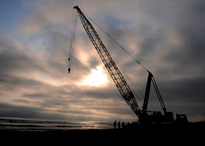 US Navy 080708-N-1424C-341 The sun sets as Seabees prepare for crane operations to construct an elevated causeway during Joint Logistics Over-The-Shore (JLOTS) 2008