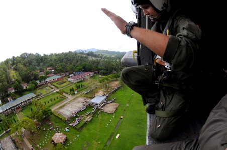 US Navy 080630-N-5961C-011 Aviation Warfare Systems Operator 2nd Class Travis Story, a native of Reading, Calif., waives goodbye to children at a school in the remote village of Altavas