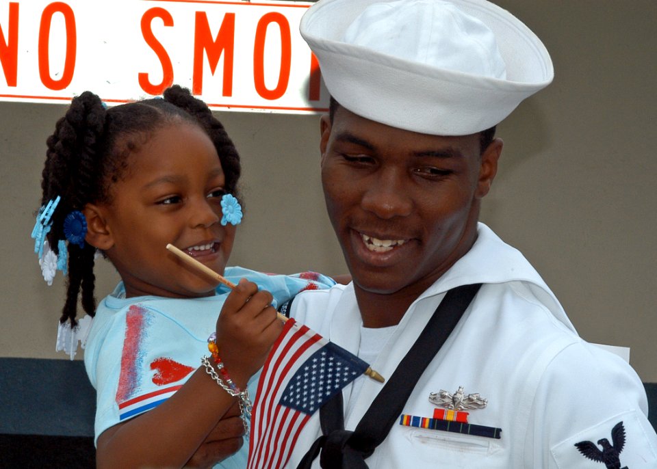 US Navy 080703-N-6410J-049 Cryptologic Technician Technical 2nd Class Charles Myers, assigned to the frigate USS Vandegrift (FFG 48), hugs his daughter after returning home from a deployment