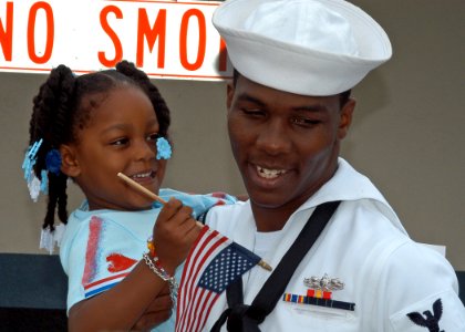 US Navy 080703-N-6410J-049 Cryptologic Technician Technical 2nd Class Charles Myers, assigned to the frigate USS Vandegrift (FFG 48), hugs his daughter after returning home from a deployment