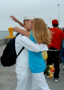 US Navy 080703-N-6410J-056 A Sailor assigned to the frigate USS Vandegrift (FFG 48) kisses his wife after returning home from a deployment
