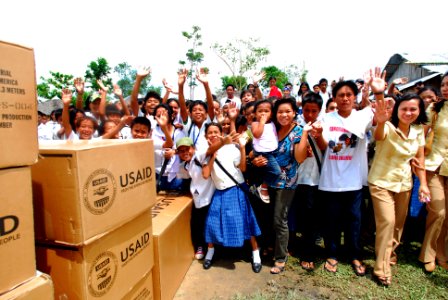 US Navy 080701-N-0640K-433 Citizens from the Municipality of Balasan, Philippines wave after receiving supplies from air crewmen assigned to the photo