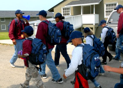 US Navy 080702-N-9860Y-002 Aviation Electronics Technician 1st Class Tyrone Vester, assigned to Electronic Attack Squadron (VAQ) 140, leads Drug Education for Youth (DEFY) camp participants on a march