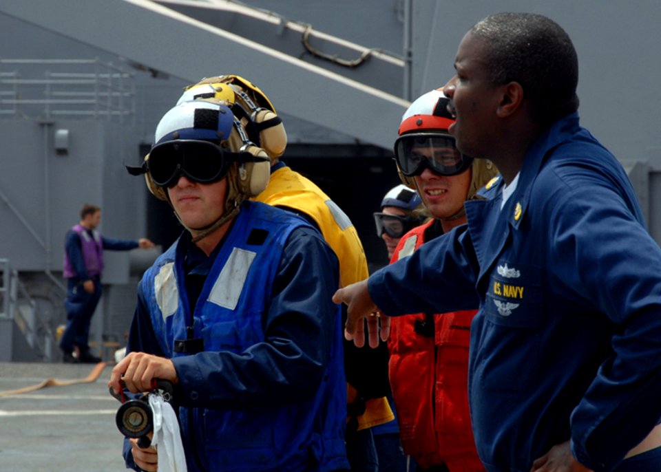 US Navy 080709-N-9134V-043 enior Chief Ship Serviceman Samuel Bouyer instructs Sailors during crash and smash training aboard the amphibious dock landing ship USS Carter Hall (LSD 50)