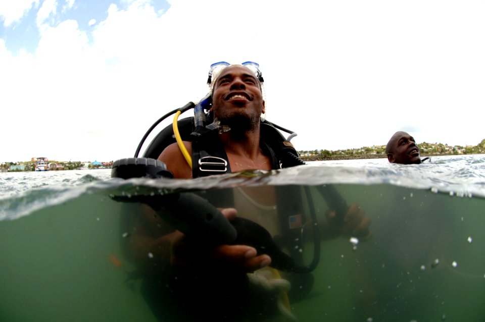 US Navy 080710-N-3093M-001 Antigua Regional Security Service Ordinary Seaman Julio L. Charles prepares to leave surface to inspect the hull of the Military Sealift Command rescue and salvage ship USNS Grasp (T-ARS 51)