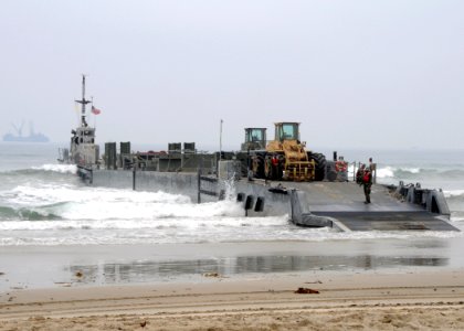 US Navy 080706-N-1424C-975 Cargo and equipment is offloaded from an improved Navy lighterage system causeway ferry