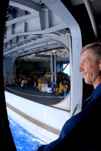 US Navy 080710-N-7730P-004 Master Chief Quartermaster Thomas Summerour casually watches over a vertical replenishment of the Nimitz-class aircraft carrier USS Ronald Reagan (CVN 76) and the Military Sealift Command fleet replen