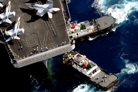 US Navy 080706-N-5961C-004 The Nimitz-class aircraft carrier USS Ronald Reagan (CVN 76) is assisted by tug boats as the ship pulls into Agana Harbor off the coast of Guam