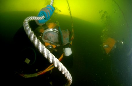 US Navy 080707-N-8298P-013 Army Staff Sgt. Joshua West lowers himself down to the sunken former Soviet submarine Juliett 484 to conduct salvage operations