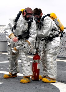 US Navy 080711-N-1082Z-046 Gas Turbine System (Mechanical) Technician 2nd Class Daniel Minaert and Gas Turbine System Technician-Mechanical Fireman Christopher J. Townsend participate in a crash and salvage drill