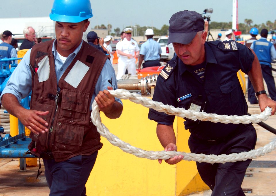 US Navy 080711-N-3285B-036 Store Keeper 2nd Class Carlos Bell (left) and a crew member of the Italian submarine ITS Salvatore Todaro (S-526) assist in line-handling as the boat prepares to pull into port at Naval Station Maypor