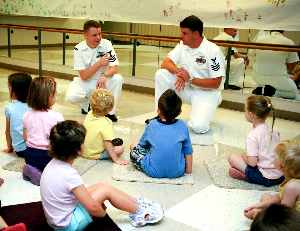 US Navy 080708-N-3271W-012 Electrician's Mate 1st Class John Campbell, left, and First Class Machinist Mate Clyde Barley, assigned to Pre-Commissioning Unit George H.W. Bush (CVN 77), speak to children at the Roanoke YMCA about