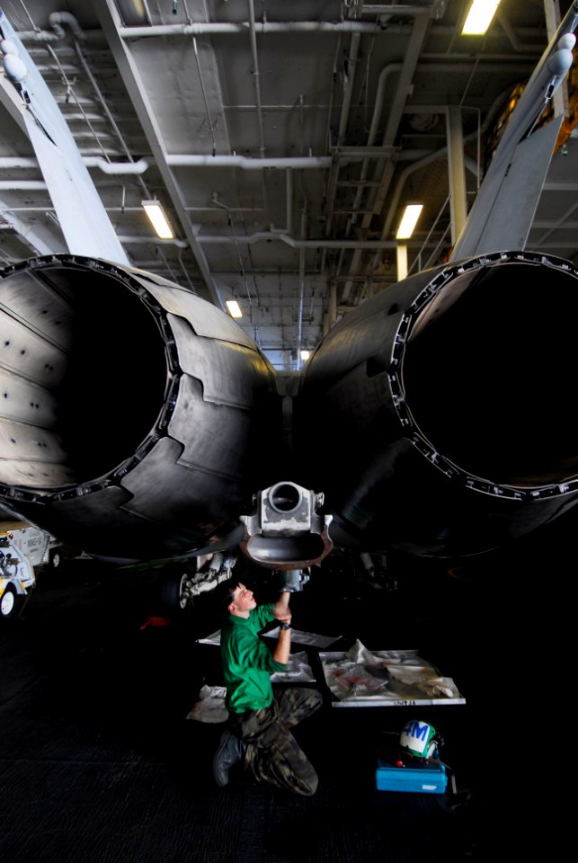 US Navy 080711-N-3946H-116 Aviation Structural Mechanic 2nd Class Wesley Goodwin, of Flint, Mich., performs maintenance on the arresting hook of a Strike Fighter Squadron (VFA) 195 F-A-18C Hornet