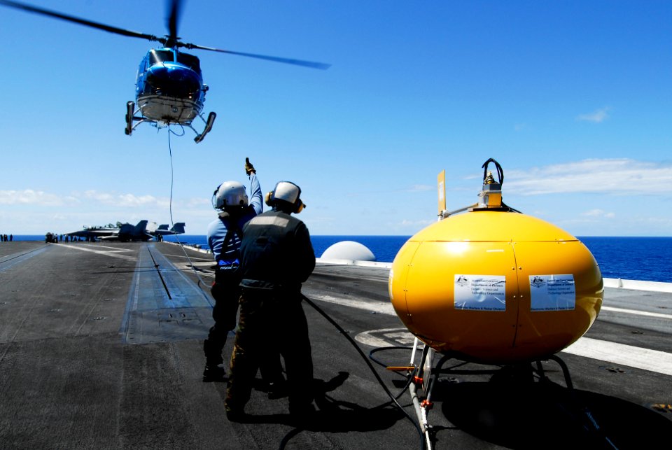 US Navy 080713-N-7883G-093 Sailors place a MK-53 Nulka Decoy Launching System on the flight deck of the aircraft carrier USS Kitty Hawk (CV 63) as it hangs from an Air Centers Inc. Bell 417 4E helicopter during Rim of the Pacif