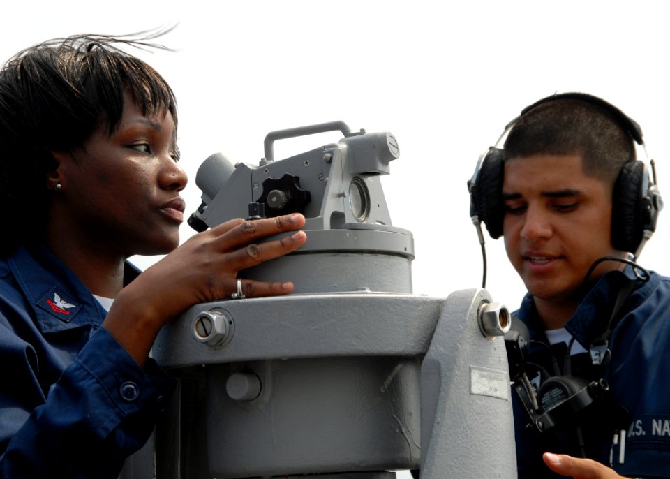US Navy 080708-N-9134V-010 Quartermaster 3rd Class Perry Avila conducts on-the-job training with Quartermaster 2nd Class Angela Everett aboard the amphibious dock landing ship USS Carter Hall (LSD 50)
