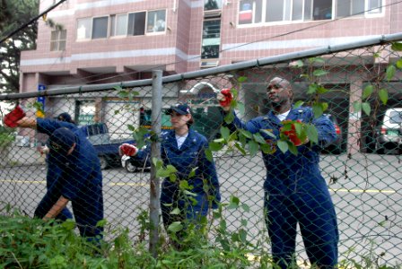 US Navy 080715-N-1635S-004 Sailors assigned to the Nimitz-class aircraft carrier USS Ronald Reagan (CVN 76) and embarked Carrier Air Wing (CVW) 14 clear overgrown vegetation