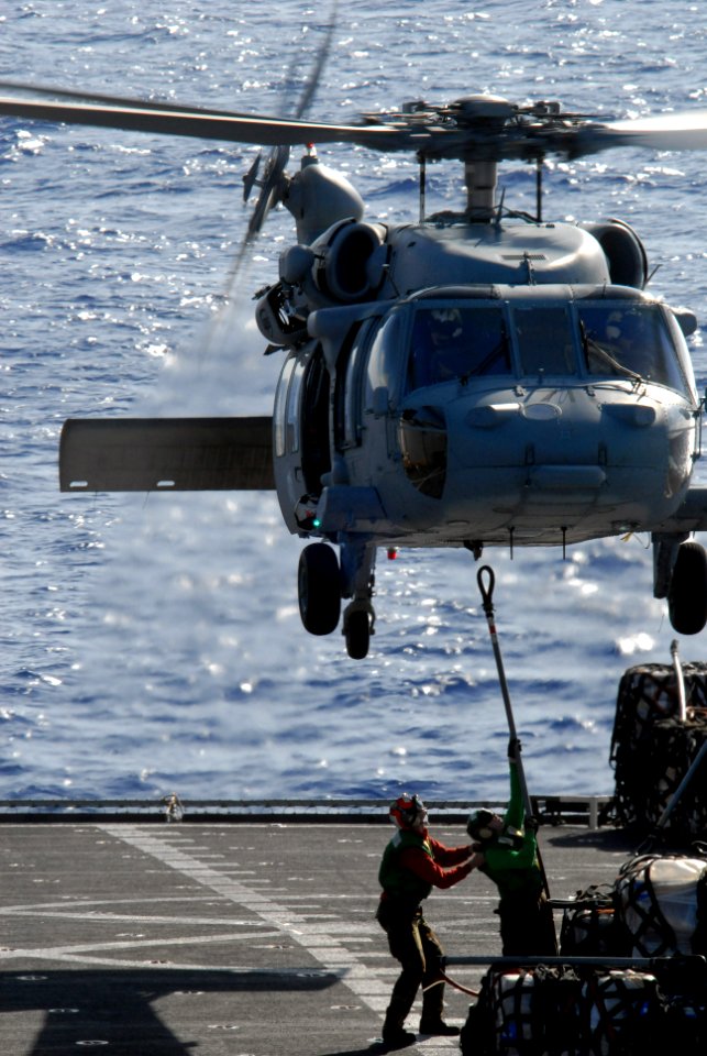 US Navy 080710-N-1635S-005 Personnel aboard the Military Sealift Command fast combat support ship USNS Bridge (T-AOE 10) attach a cargo pendant to an MH-60S Seahawk