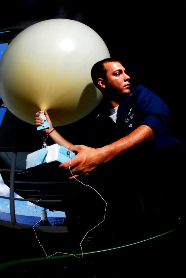 US Navy 080709-N-7883G-031 Aerographer's Mate 2nd Class Kristopher Rodriguez, of Baltimore, prepares to release a weather balloon from the fantail of the aircraft carrier USS Kitty Hawk (CV 63)