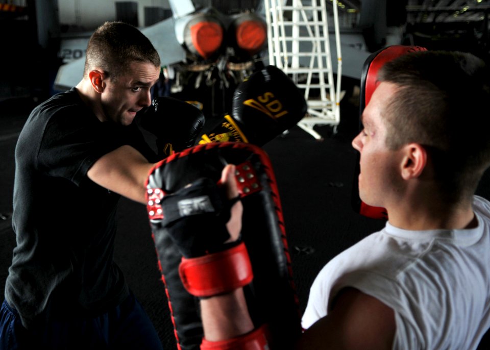US Navy 080715-N-7981E-273 Machinist's Mate 3rd Class Yuri Hardt, from Washougac, Wash., spars with his training partner, Machinist's Mate 3rd Class Chris Franz, from Emporia, Kansas, during their boxing and mixed martial arts