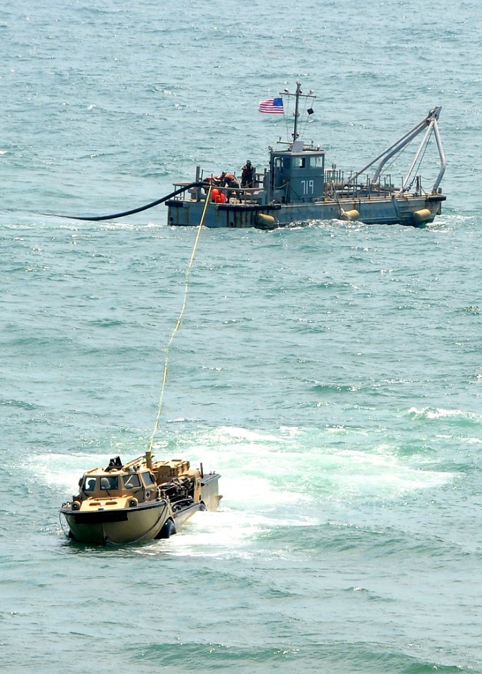 US Navy 080713-N-1424C-320 Members of Beach Master Unit (BMU) 1 drag offshore petroleum discharge system conduit hose to shore during Joint Logistics Over-The-Shore (JLOTS) 2008