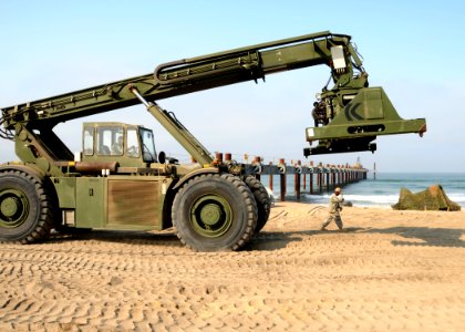 US Navy 080716-N-1424C-593 A Kalmar Rough Terrain Container Handler travels along Red Beach during the construction of the elevated causeway system photo