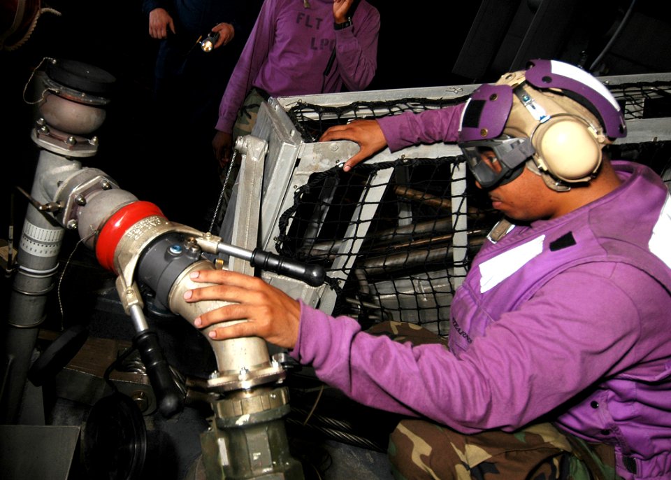US Navy 080715-N-5681S-026 Aviation Boatswain's Mate Fuel 3rd Class Patrick Knight takes a fuel sample while refueling a landing craft air cushion aboard the multi-purpose amphibious assault ship USS Iwo Jima (LHD 7)