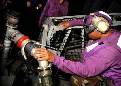 US Navy 080715-N-5681S-026 Aviation Boatswain's Mate Fuel 3rd Class Patrick Knight takes a fuel sample while refueling a landing craft air cushion aboard the multi-purpose amphibious assault ship USS Iwo Jima (LHD 7) photo