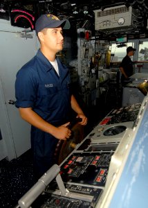 US Navy 080711-N-4236E-018 Seaman Allen Parces steers the guided-missile cruiser USS Vella Gulf (CG 72) during the Iwo Jima Expeditionary Strike Group composite unit training exercise photo