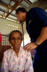 US Navy 080716-N-0209M-002 Capt. Kenneth Eisenberg checks a patient's heart rate at a Pacific Partnership medical civic action program at Nularn 1 Elementary School