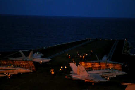 US Navy 080711-N-3659B-244 Aircraft are readied for launch off the bow catapults of the Nimitz-class aircraft carrier USS Ronald Reagan (CVN 76) during night flight operations