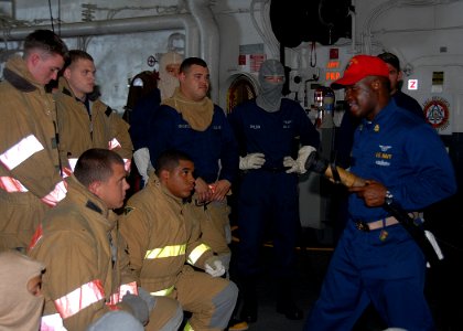 US Navy 080714-N-6999H-023 Damage control training team member Chief Air Traffic Controller Torrence Kelly gives training to repair locker members