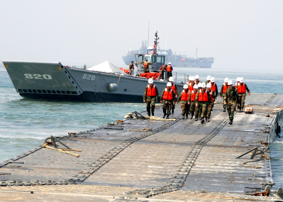 US Navy 080718-N-1424C-953 ivil Engineer Corp students take a tour of the Admin Pier as Assault Craft Unit (ACU) 1 landing craft mechanized departs the pier during Joint Logistics Over-The-Shore (JLOTS) 2008