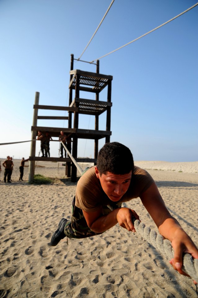 US Navy 080715-N-2959L-213 Seaman Apprentice Giovanny Magallon pulls himself along a rope while participating in an obstacle course