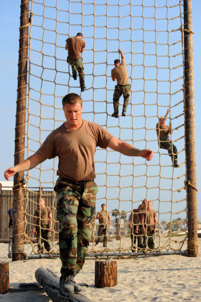 US Navy 080715-N-2959L-083 Seaman Kristopher Linton concentrates on keeping his balance while participating in an obstacle course