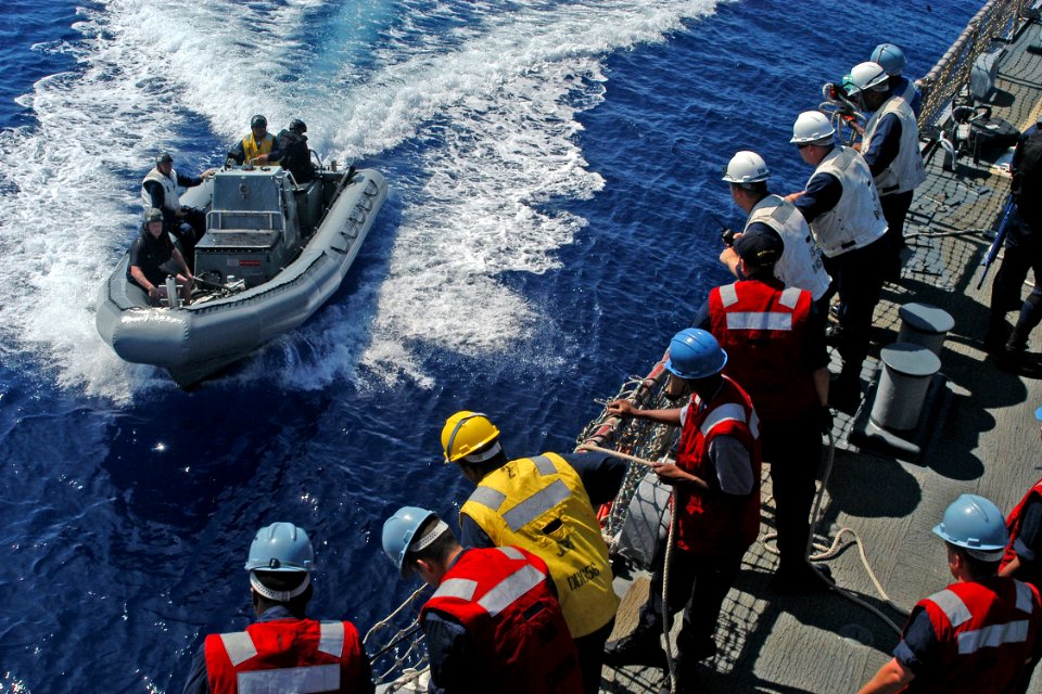 US Navy 080715-N-9123L-003 Sailors stand by as a rigid hull inflatable boat approaches the starboard side of the guided-missile destroyer USS John S. McCain (DDG 56)