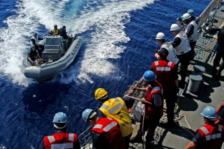 US Navy 080715-N-9123L-003 Sailors stand by as a rigid hull inflatable boat approaches the starboard side of the guided-missile destroyer USS John S. McCain (DDG 56)