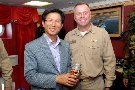 US Navy 080713-N-1635S-003 Capt. Kenneth J. Norton, commanding officer of the Nimitz-class aircraft carrier USS Ronald Reagan (CVN 76), presents a gift of jellybeans to Governor Moon Soo Kim photo