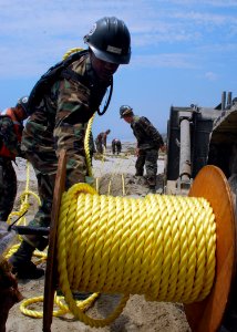 US Navy 080713-N-4973M-162 Seaman Jamar Warren, assigned to Amphibious Construction Battalion (ACB) 1, unravels 600 feet of line on Red Beach during Joint Logistics Over-The-Shore (JLOTS) 2008 photo