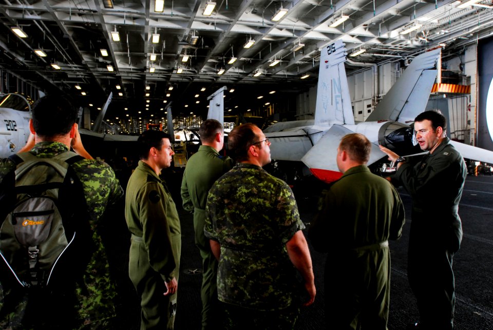 US Navy 080715-N-7883G-016 Lt. Josh Hall gives a tour to pilots and enlisted personnel assigned to Canadian 409 Tactical Fighter Squadron.