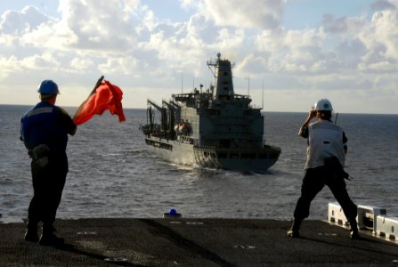 US Navy 080716-N-6999H-017 Boatswain's Mate Seaman Apprentice Mason West, left, and Boatswain's Mate 2nd Class Ashlie Bevin take bearing measurements