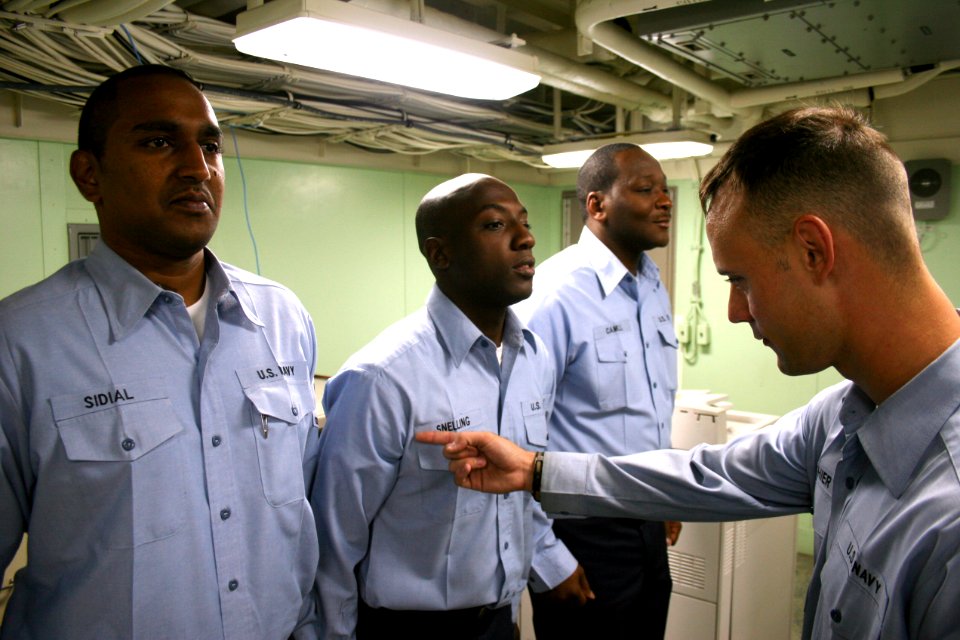 US Navy 080716-N-6764G-324 Yeoman 2nd Class Henry Gauthier inspects Sailors' uniforms aboard the amphibious transport dock ship USS San Antonio (LPD 17)
