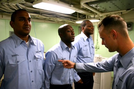 US Navy 080716-N-6764G-324 Yeoman 2nd Class Henry Gauthier inspects Sailors' uniforms aboard the amphibious transport dock ship USS San Antonio (LPD 17)