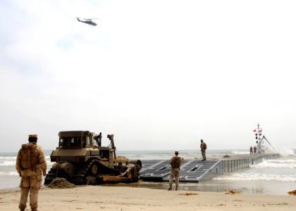 US Navy 080717-N-1424C-860 A Bulldozer pushes an Army lighterage out to sea during Joint Logistics Over-The-Shore (JLOTS) 2008