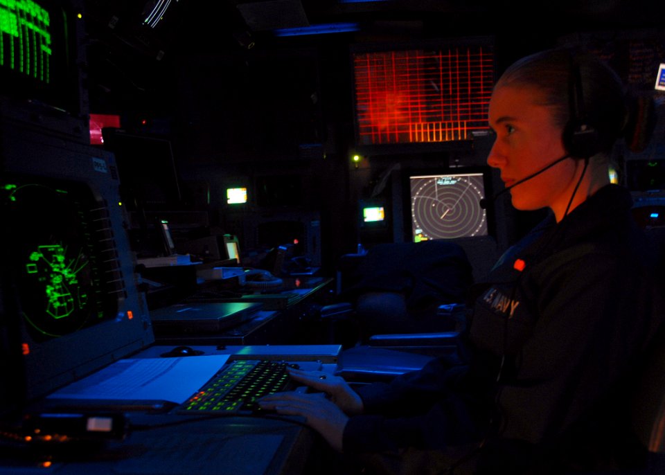 US Navy 080720-N-6999H-026 Operations Specialist Seaman Jessica Thayer inputs flight information for next day air times while standing the automatic status board operator watch in the tactical air control center aboard the amph